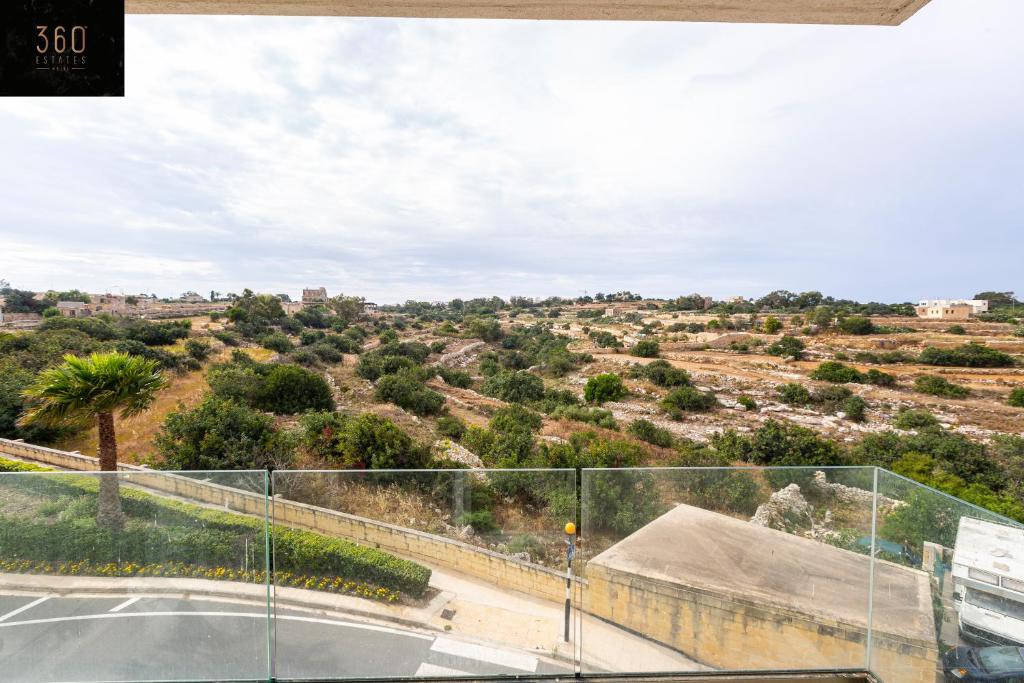 une vue sur un désert avec une clôture et une route dans l'établissement Serene 2BR Apartment with Picturesque Views by 360 Estates, à Marsaxlokk
