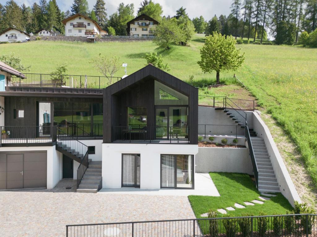 a modern house with a black roof at Villa Rames in Ortisei