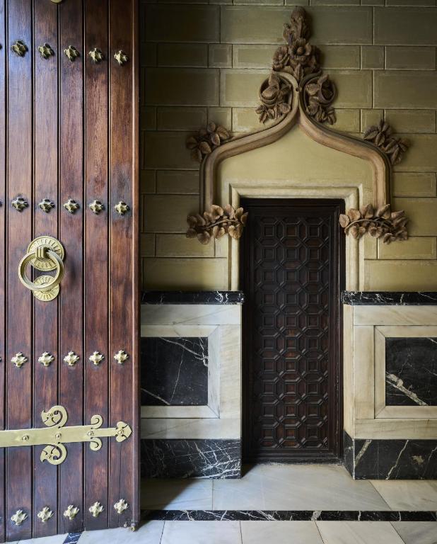 a large wooden door in a building at Catalonia El Pilar in Zaragoza