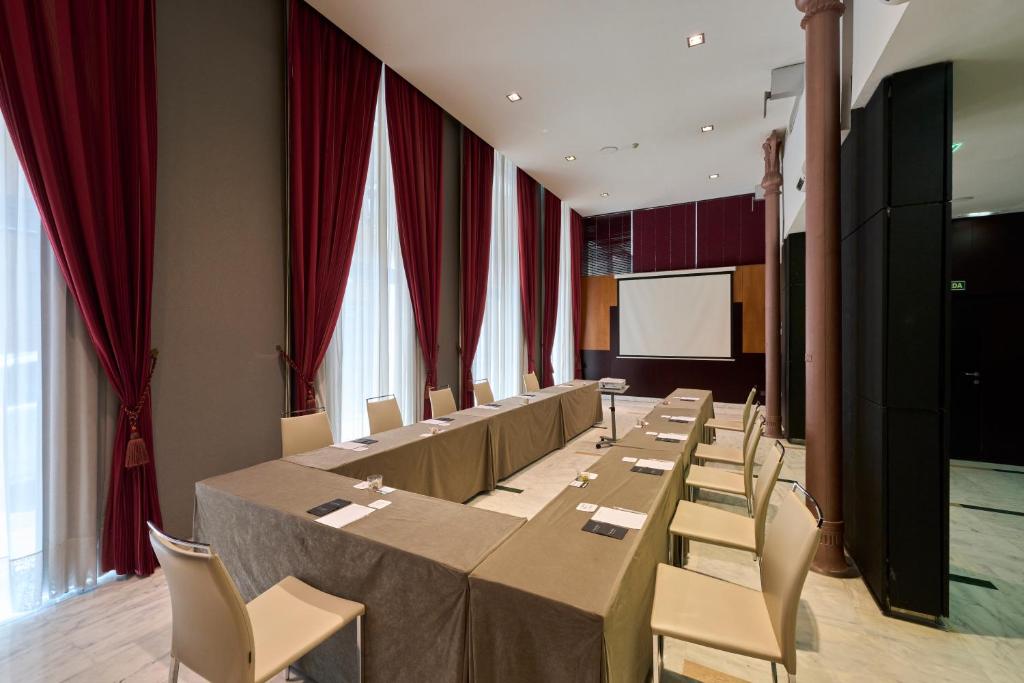 a conference room with a long table and chairs at Catalonia El Pilar in Zaragoza