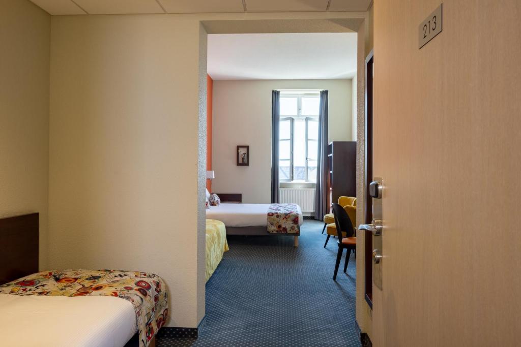 Postel nebo postele na pokoji v ubytování Hôtel Val-Vignes Colmar Haut-Koenigsbourg, The Originals Relais