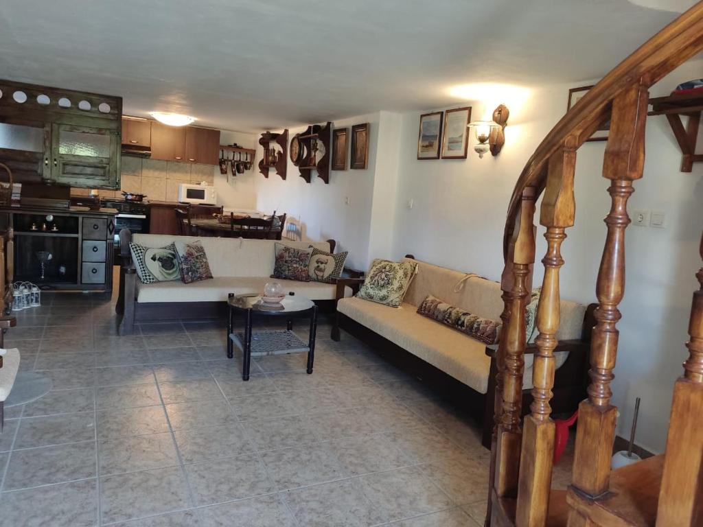 a living room with a couch and a table at KATKA Karavas in Kythira