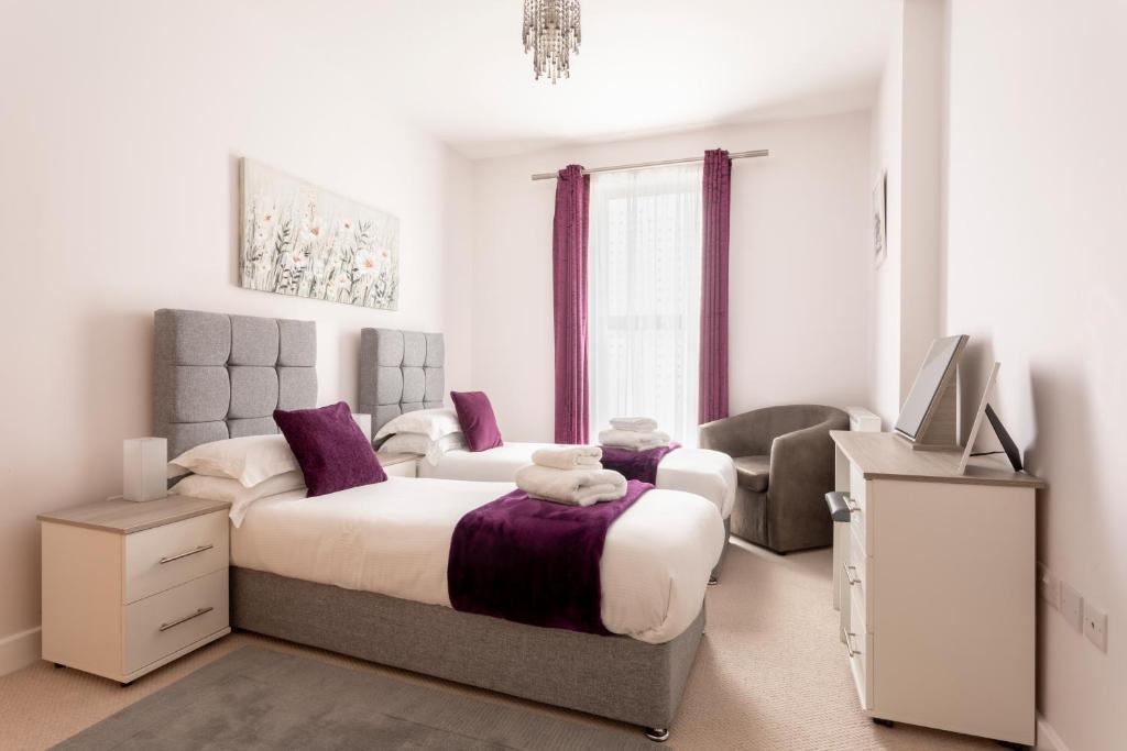 a bedroom with a large bed and a television at Queens Lodge, Redhill in Redhill