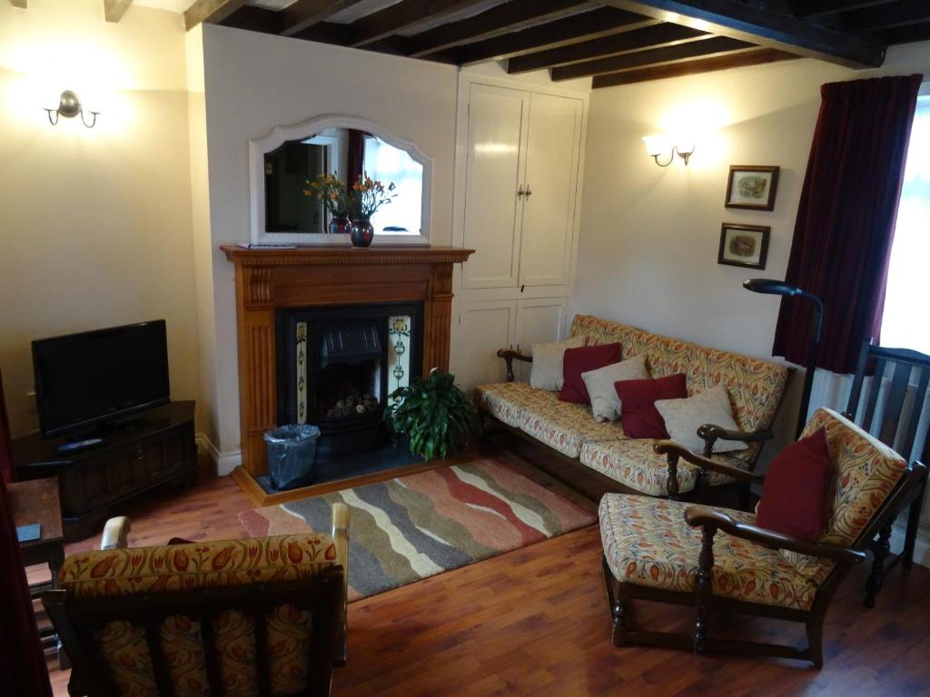 a living room with a couch and a fireplace at Flo's Cottage self-catering in Newark upon Trent