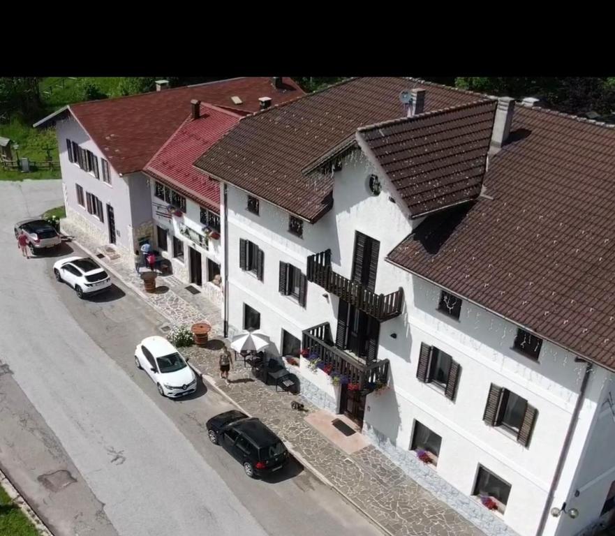 an overhead view of a large white building with cars parked outside at Monterovere in Albergo Monte Rovere
