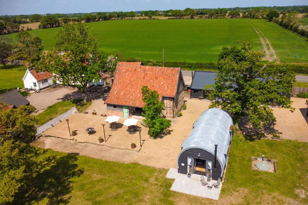 an aerial view of a house with a tin roof at The Barns at Green Valley Farm in Heveningham