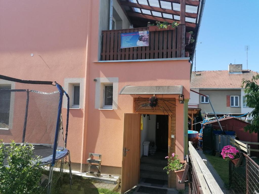 a house with a balcony and a door at Rodinný půldomek s vybavením a bazenem in Zruč nad Sázavou