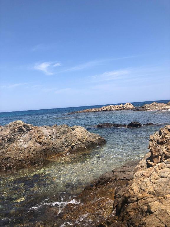 a view of the ocean with rocks in the water at Jolie T2 bord de mer corse du sud in Conca