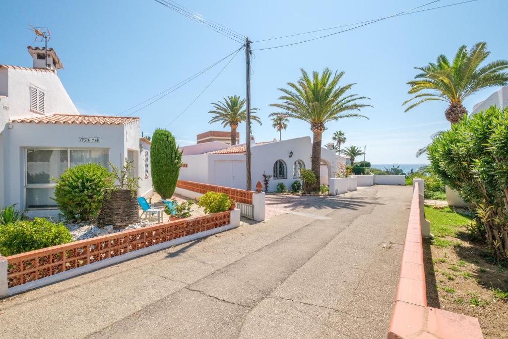 a street in front of a house with palm trees at Vistamar 4 in Vinarós