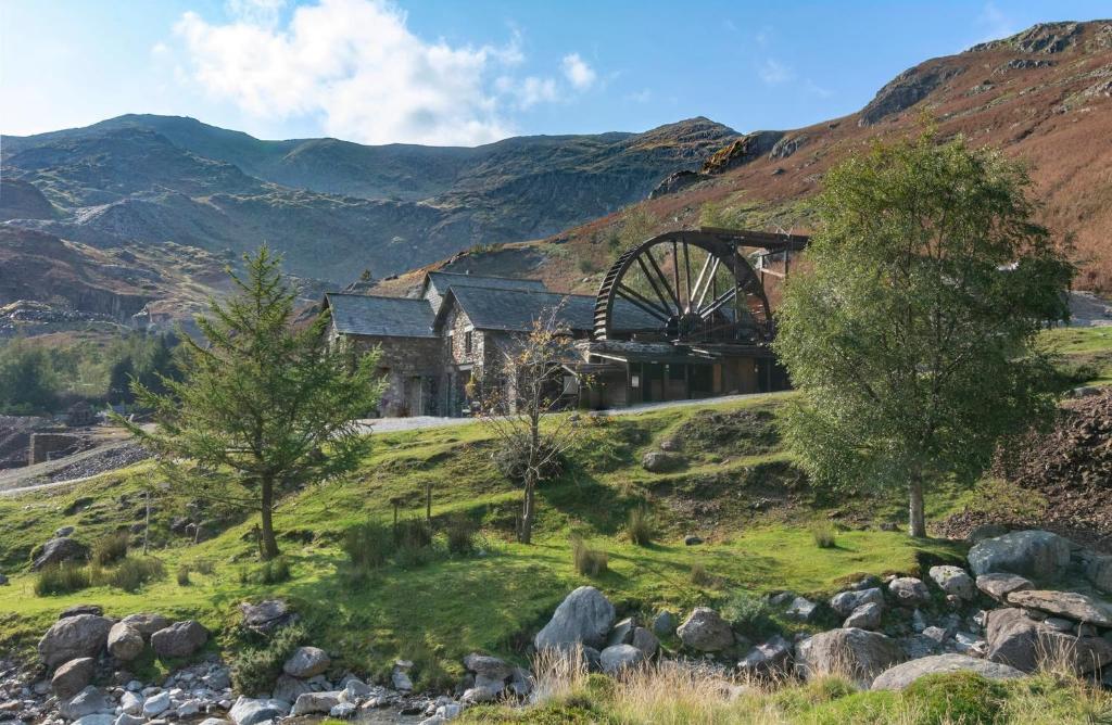 an old mill in the middle of a mountain at The Coppermines Mountain Cottages - Sawyers, Millrace, Pelton Wheel, Sleeps 16 in Coniston