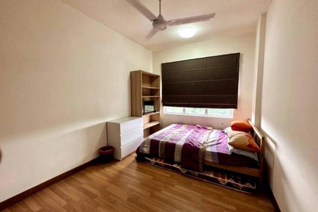 a small bedroom with a bed and a window at Green-Scenery Suburban by Irdina's Homestay in Kampong Perimbun