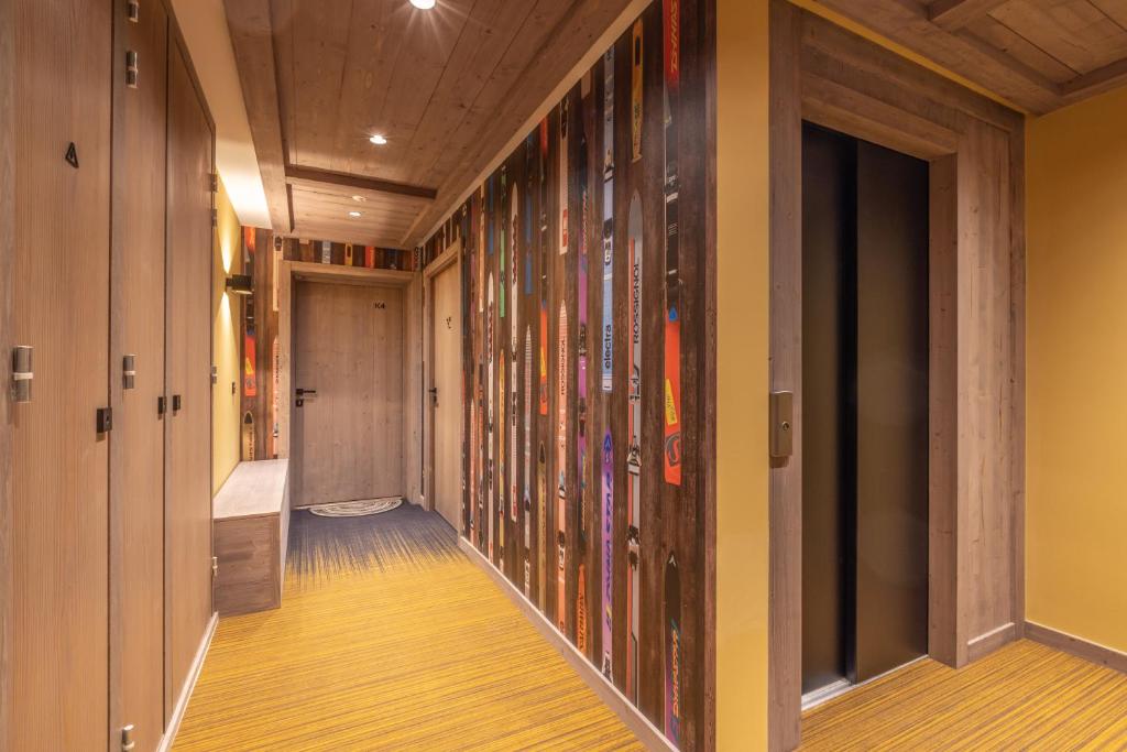 a hallway with colorful glass panels on the wall at Bleu Eskape - Appartement in Megève
