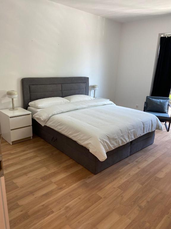 a bedroom with a large bed and a wooden floor at Hansehaus Lübeck - Stadtnest in Lübeck