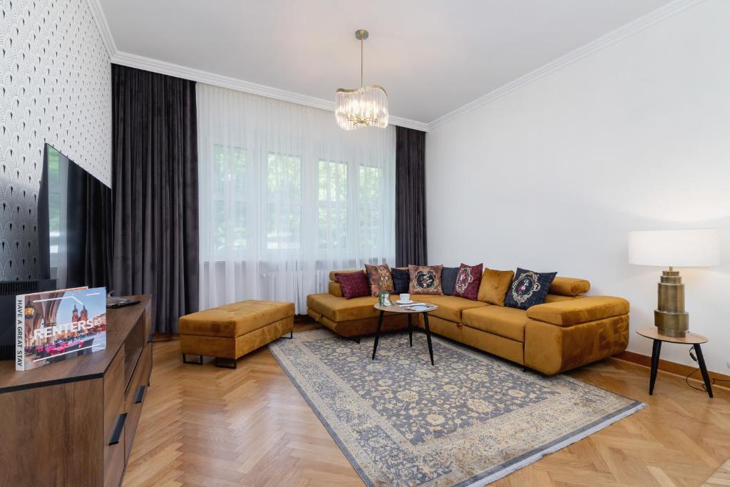 a living room with a couch and a tv at Luxurious & Unique Apartment Mickiewicza Cracow by Renters Prestige in Kraków