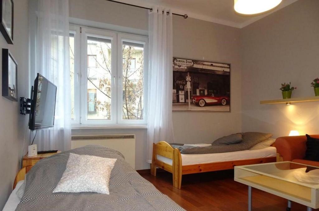 Postel nebo postele na pokoji v ubytování Cybulskiego Guest Rooms
