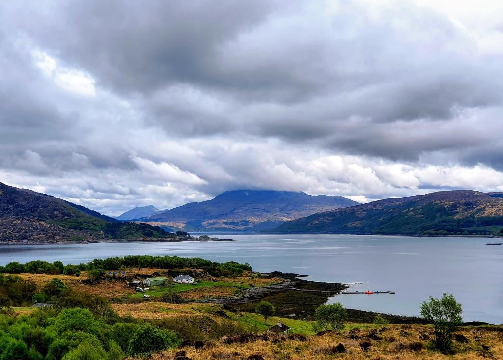 a view of a large body of water with mountains at Isle of Carna, secluded Scottish Island, Loch Sunart in Acharacle