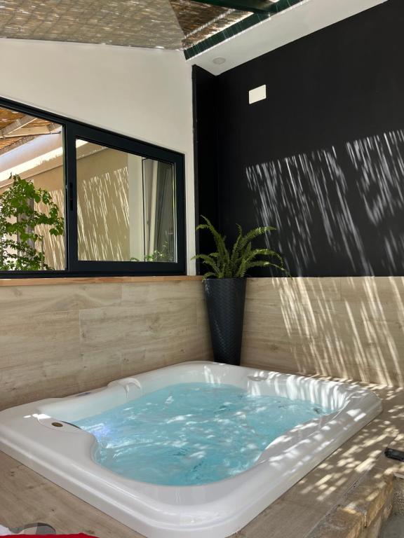 a jacuzzi tub in a room with a waterfall at Romantic apartments in Šibenik