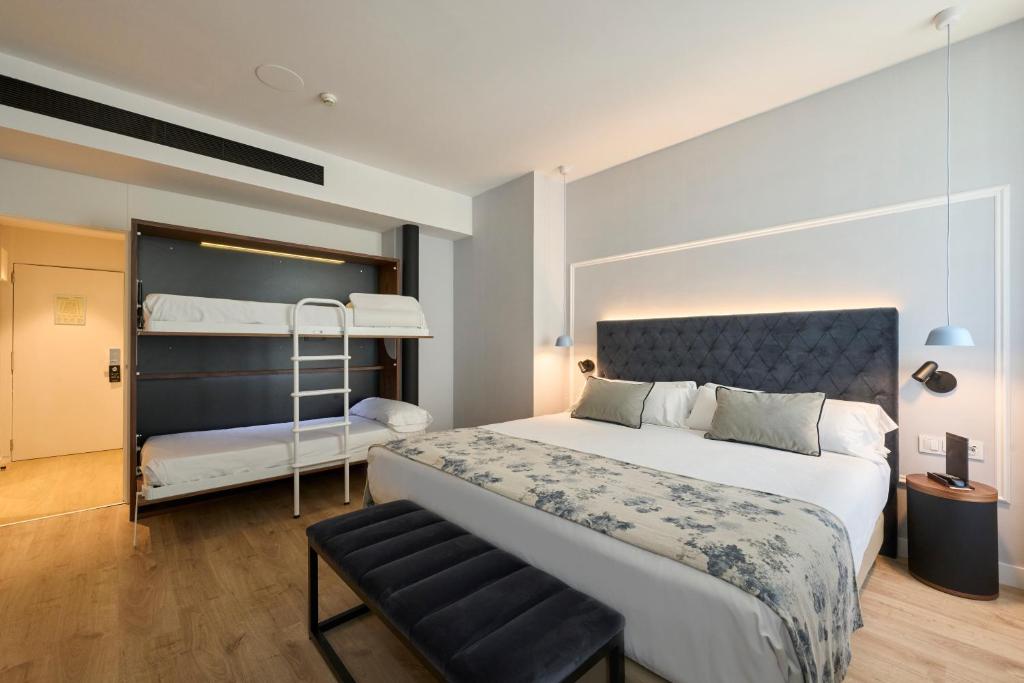 a bedroom with a bed and a bunk bed at Catalonia El Pilar in Zaragoza