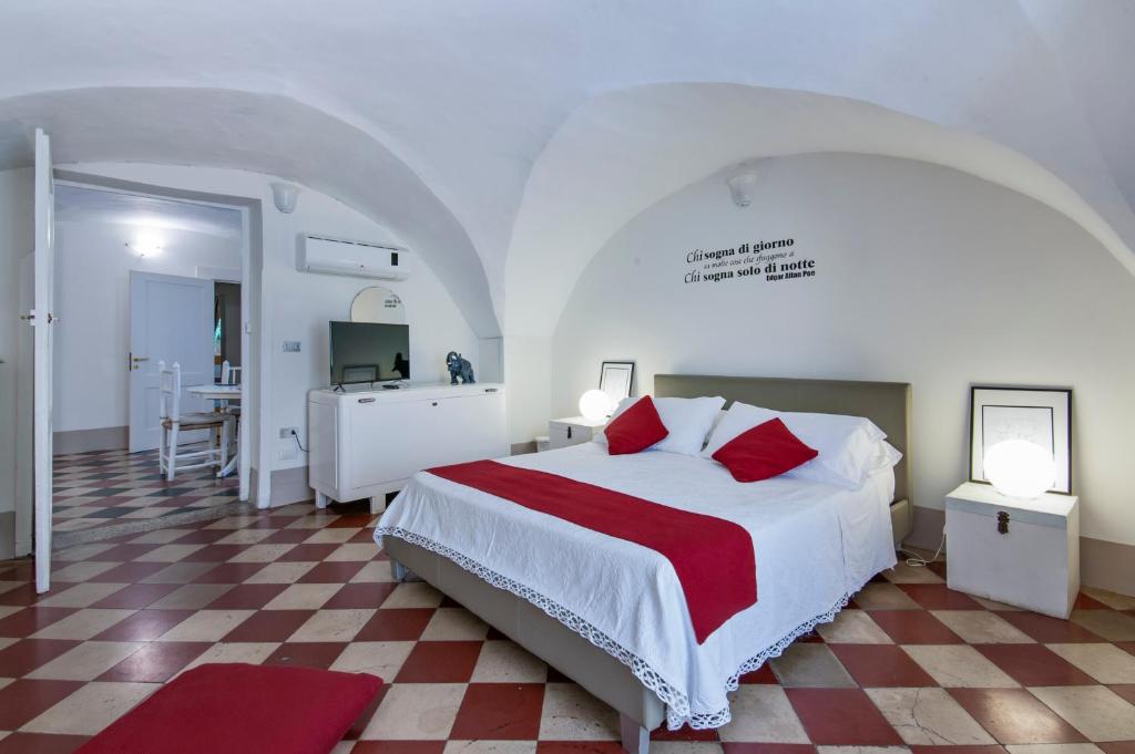 a bedroom with a large bed with a red and white blanket at Le Stanze Del Poeta - SIT Rooms in Lecce