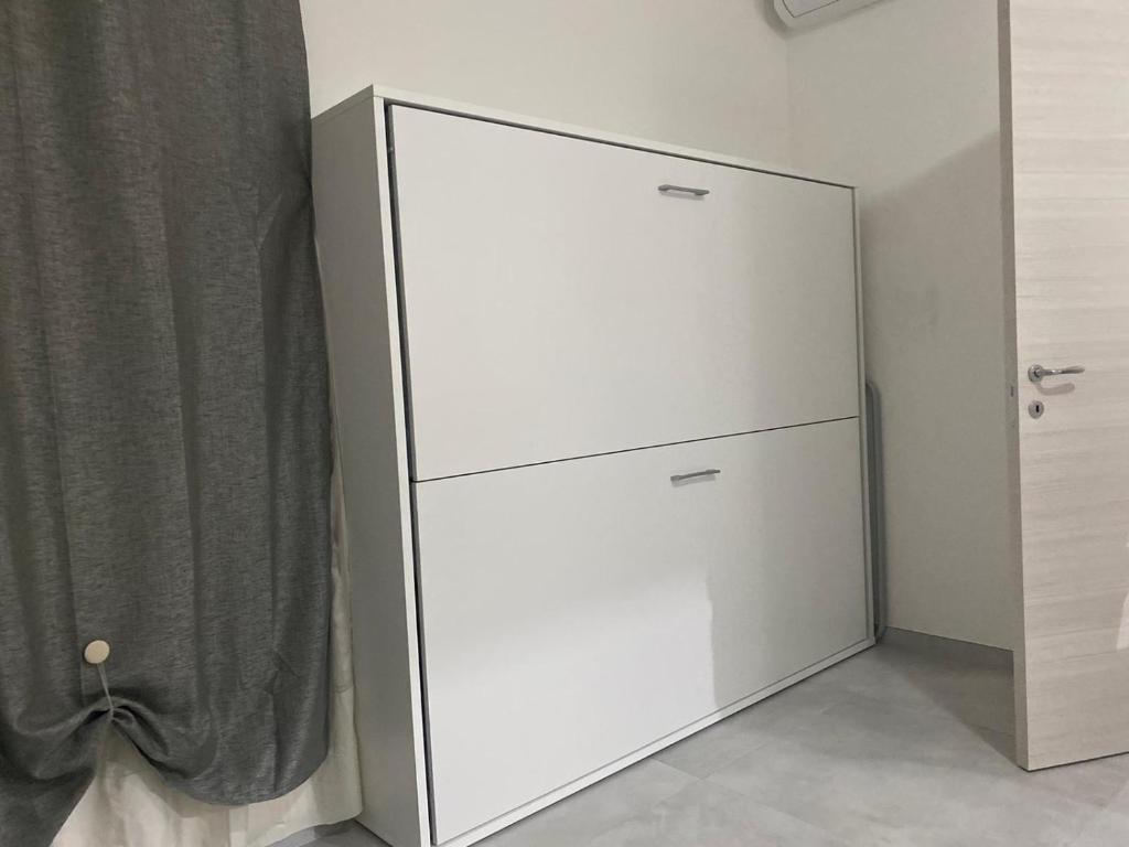 un armario blanco en una esquina de una habitación en CADORNA, en Santa Maria del Cedro