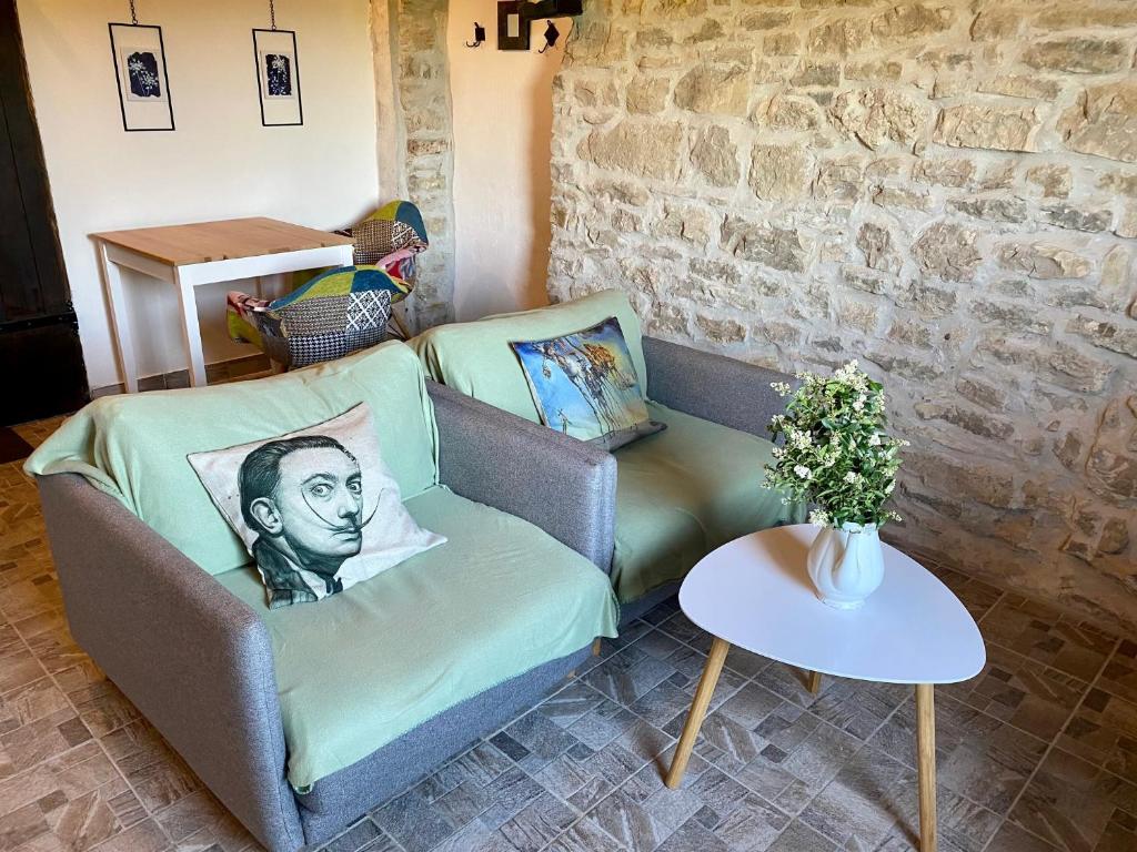 a living room with a couch and a table at Lucky Home - Apartment Art Grožnjan in Grožnjan
