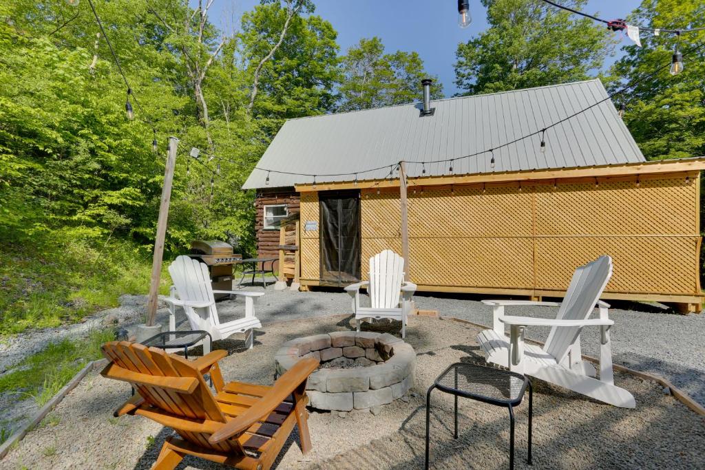 a group of chairs and a fire pit in front of a cabin at Private Cabin Rental in the Catskill Mountains! in Hamden