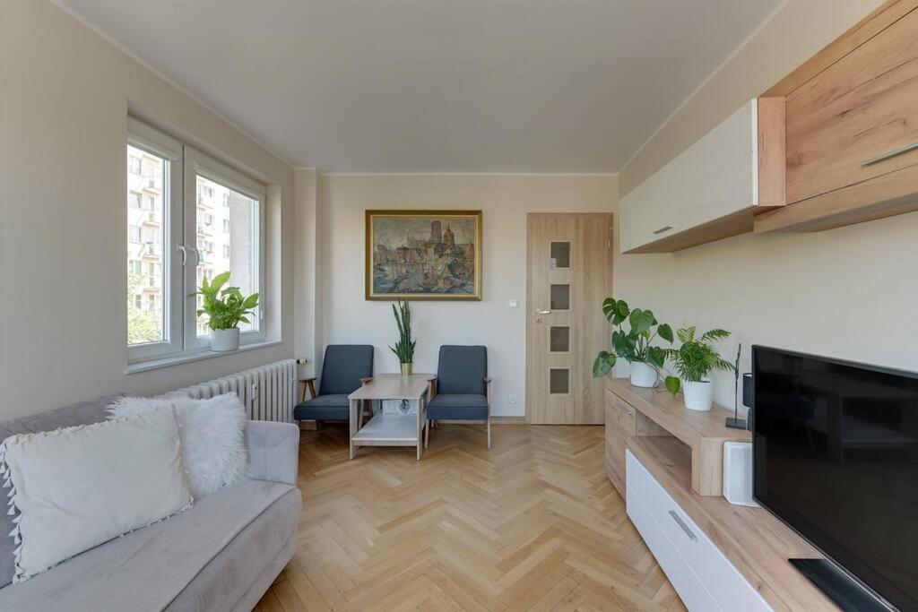 a living room with a couch and a table at Motława 1 by Grand Apartments in Gdańsk
