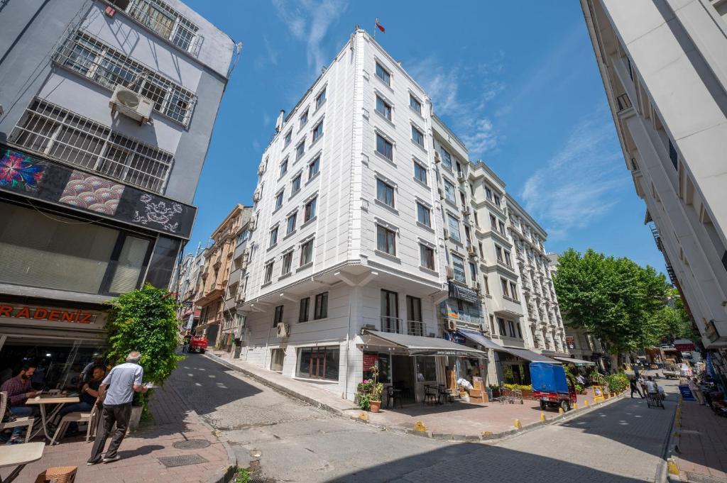 a tall white building on a city street at Boutique Dedem Hotel Sultanahmet in Istanbul