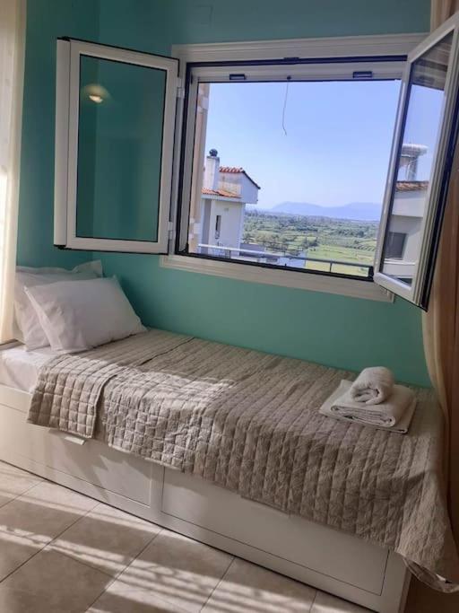 Кровать или кровати в номере SIMOS' sea view house