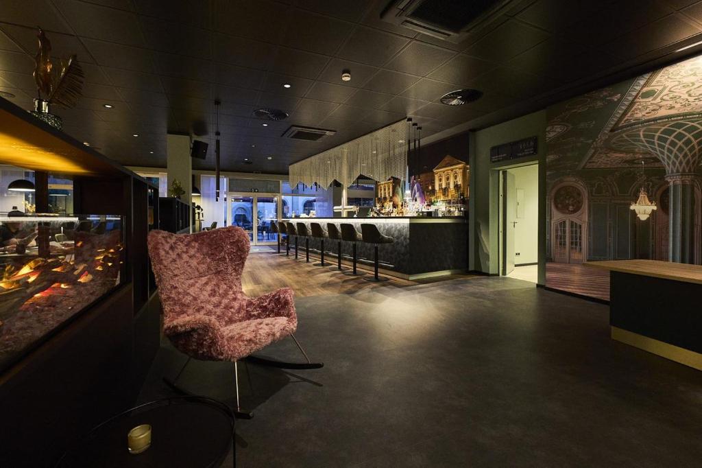 a room with a bar with a chair and a counter at Hotel Rhönkitz in Bad Kissingen