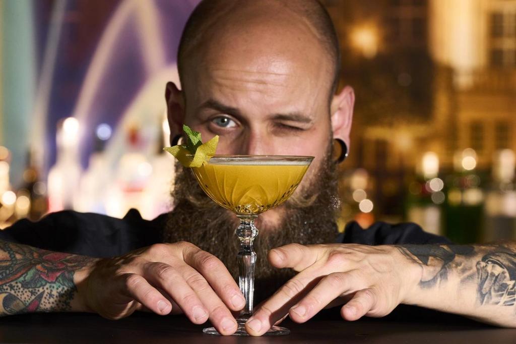 a man with a beard is holding a drink at Hotel Rhönkitz in Bad Kissingen