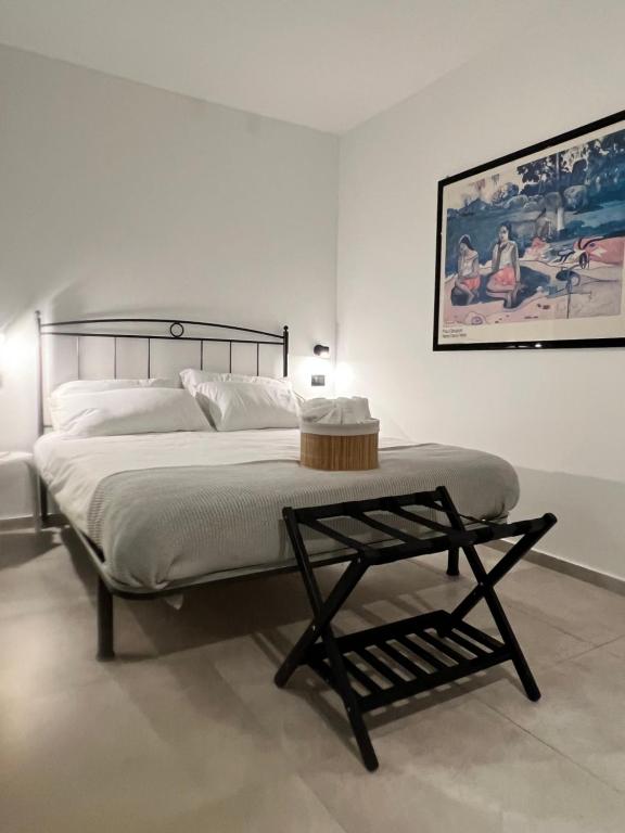 a bedroom with a bed with a table on it at Ca Rota house free parking in Lipomo