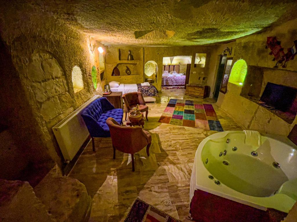 Habitación con bañera y dormitorio. en Heritage Cave Suites, en Ürgüp