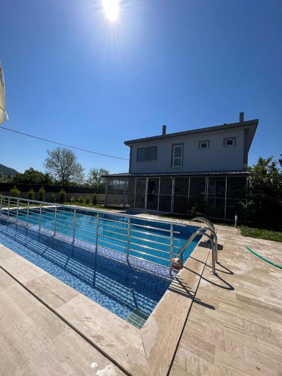 uma grande piscina com escorrega em frente a uma casa em Villa bliss em Muğla