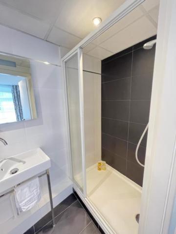 a bathroom with a shower and a sink at Residence OLit Cathédrale in Strasbourg