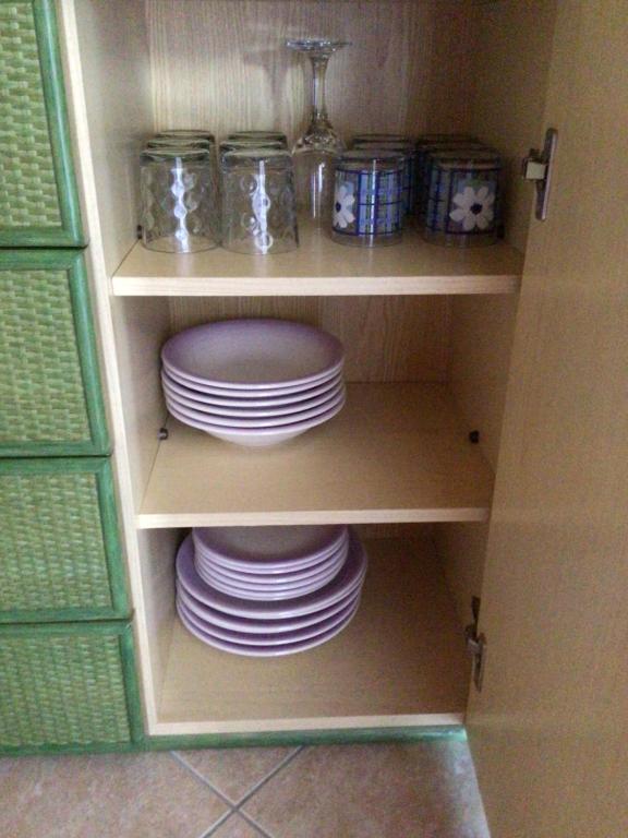 a cupboard filled with plates and bowls at Casale el galet in Moniga