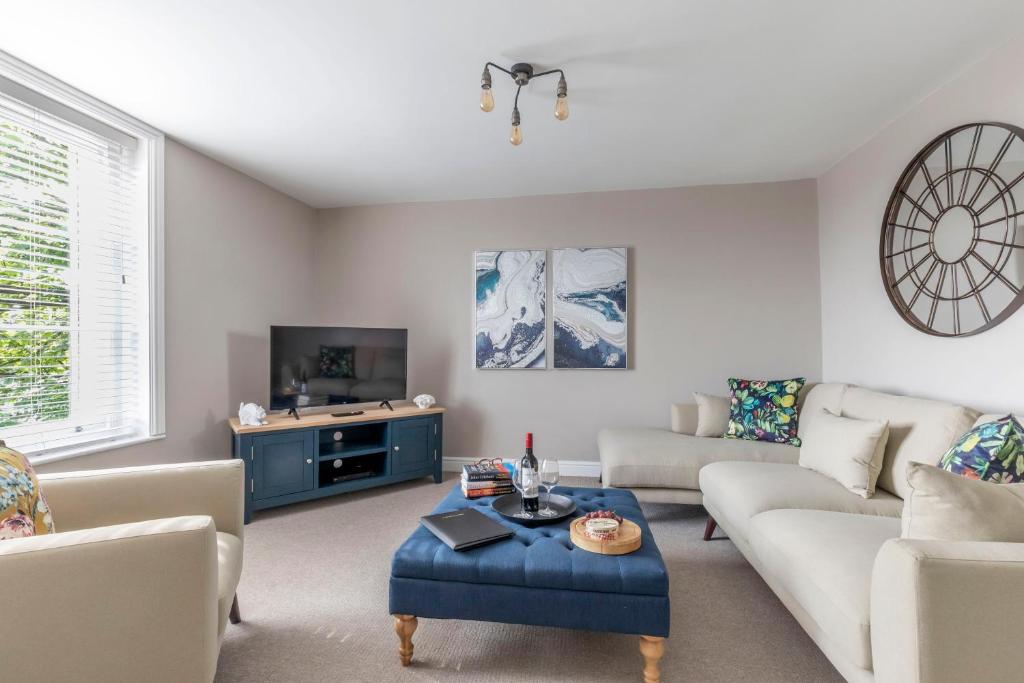 a living room with a couch and a table at Vaughan Lodge- Stunning 2 Bedroom Duplex Apartment in Malvern Wells