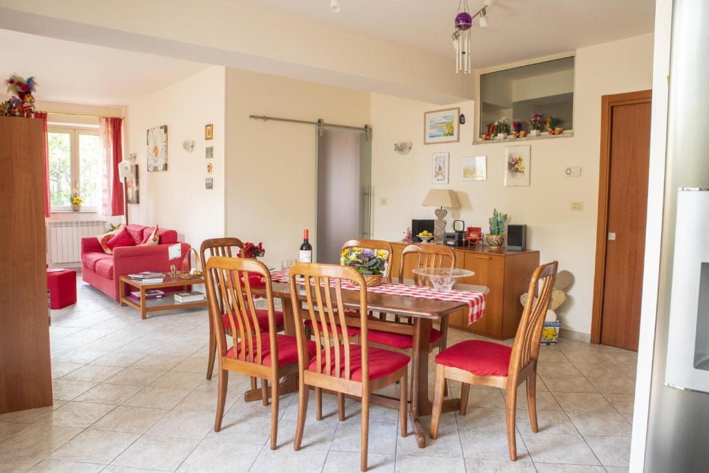 a dining room and living room with a table and chairs at Casa Limoncello in Taormina