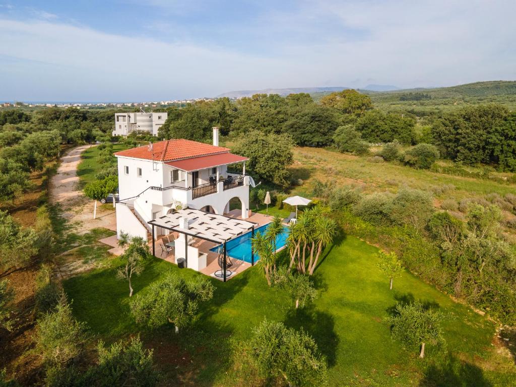 an aerial view of a house with a swimming pool at Villa Eirini Lake Kournas 3 bed and pool Chania in Mouríon