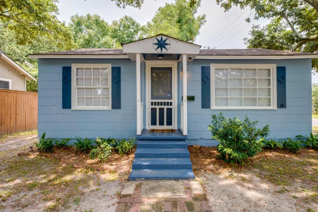 a blue house with a star on the front door at Cozy 3 Oaks Cottage in Gulfport Close to Beach! in Gulfport