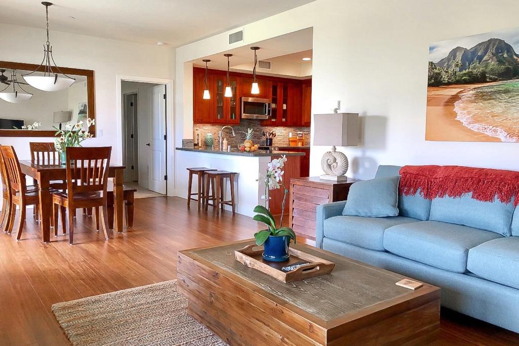 a living room and kitchen with a couch and a table at Pili Mai 7H in Koloa