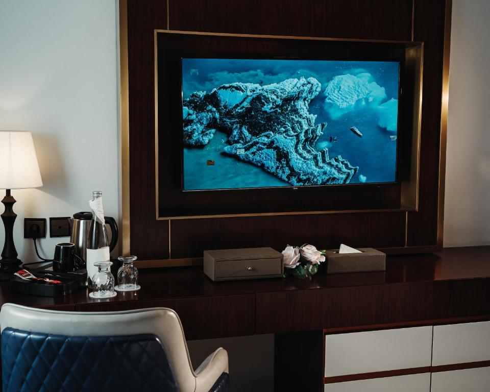 a room with a desk with a television on it at Waves Aqua Resort in Kenitra