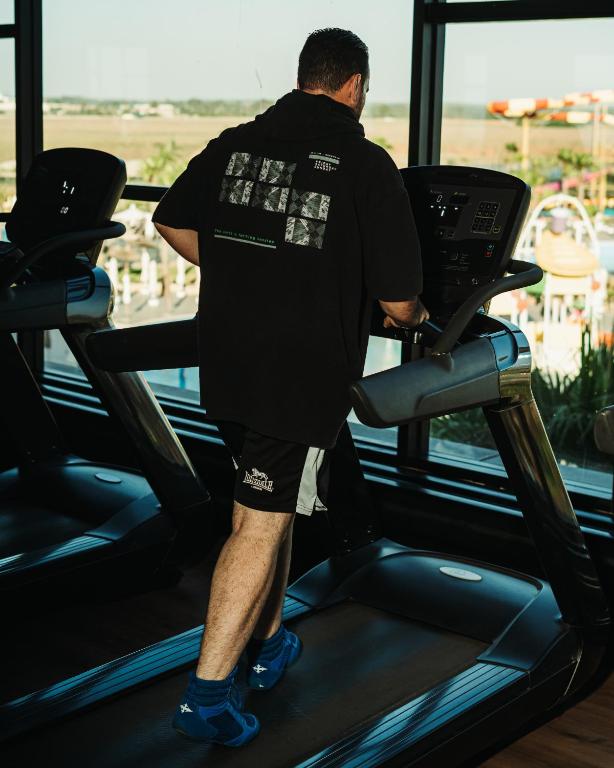 a man walking on a treadmill in a gym at Waves Aqua Resort in Kenitra