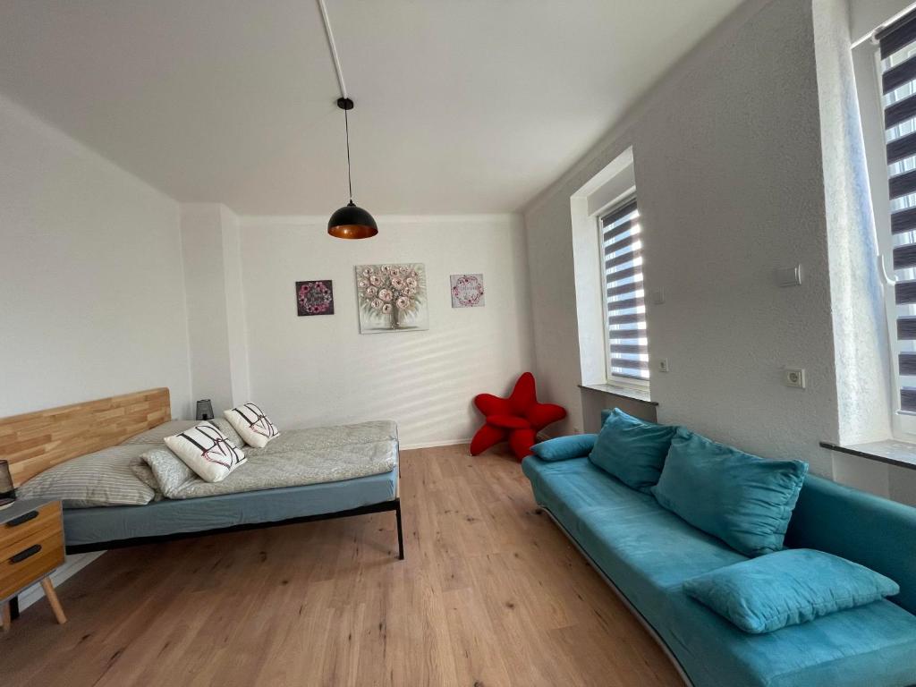 a living room with a couch and a bed at Apartment Mirabelle 2 in Püttlingen