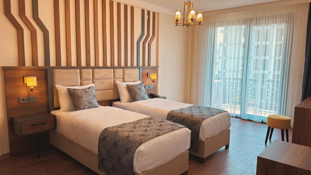 Postel nebo postele na pokoji v ubytování BİLİRİS HOTEL