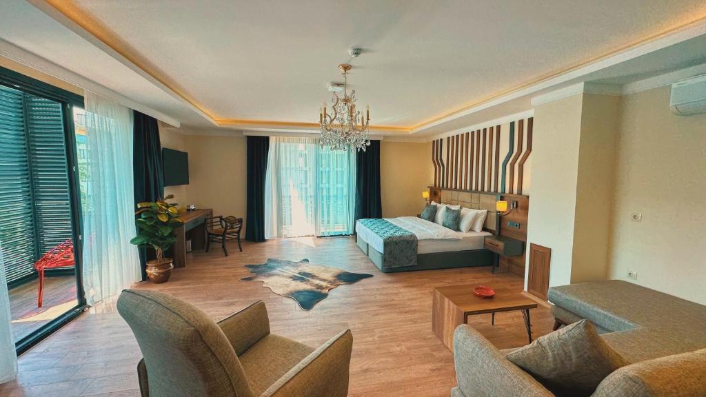 a living room with a bed and a couch at BİLİRİS HOTEL in Trabzon