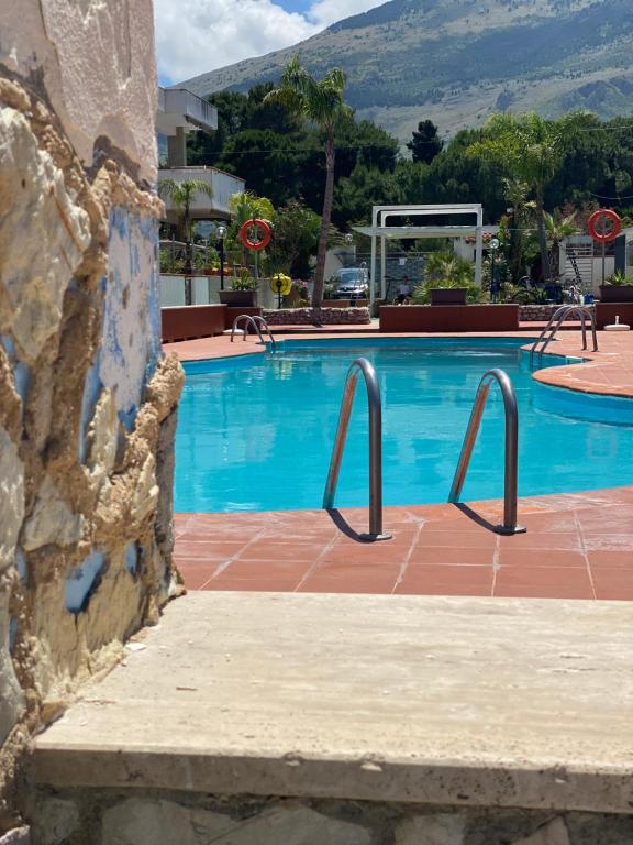 a swimming pool with two metal bars in a resort at Cala Holidays vicino Aeroporto&Mare in Carini