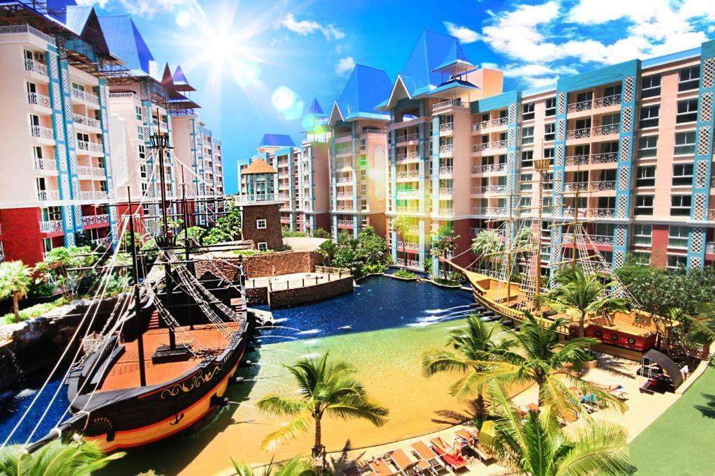 a view of a resort with boats in the water at Grande Caribbean Resort in Pattaya South
