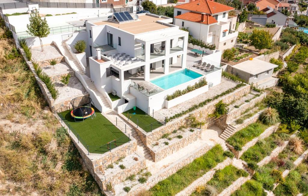 an aerial view of a house with a swimming pool at Luxury Villa Mandy - Split in Žrnovnica