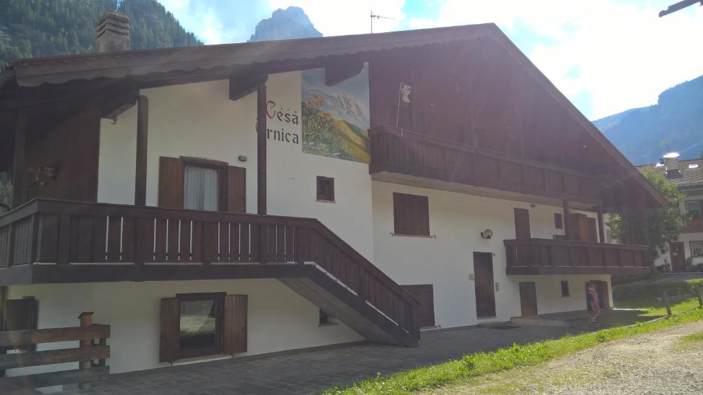 a building with a staircase on the side of it at Arnica in Canazei